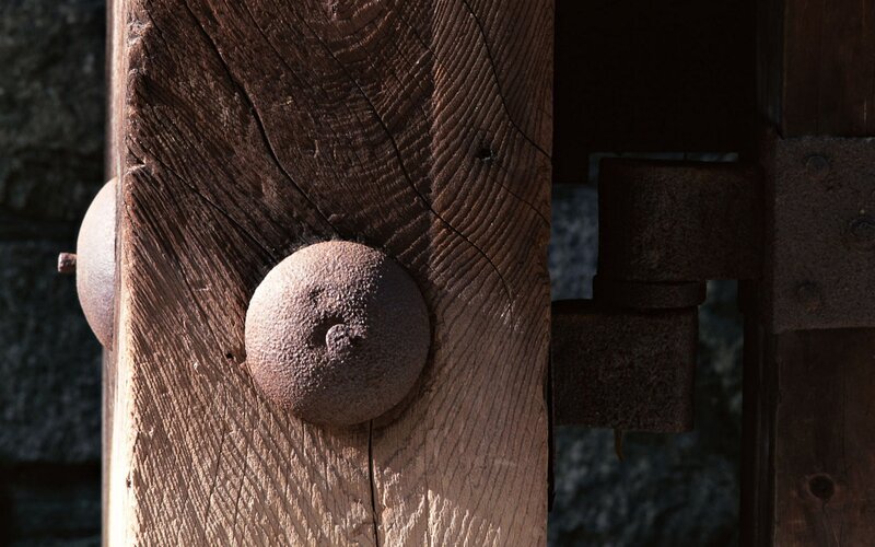 rusty bolts on wooden beam