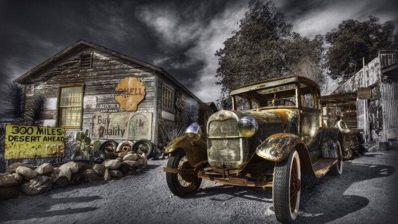 Rusty car at old gas station