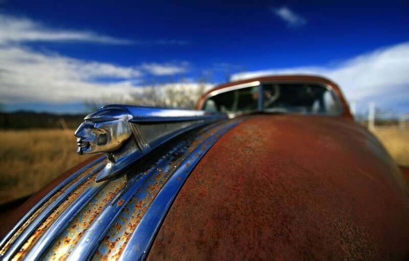 Rusty car hood with chrome ornament