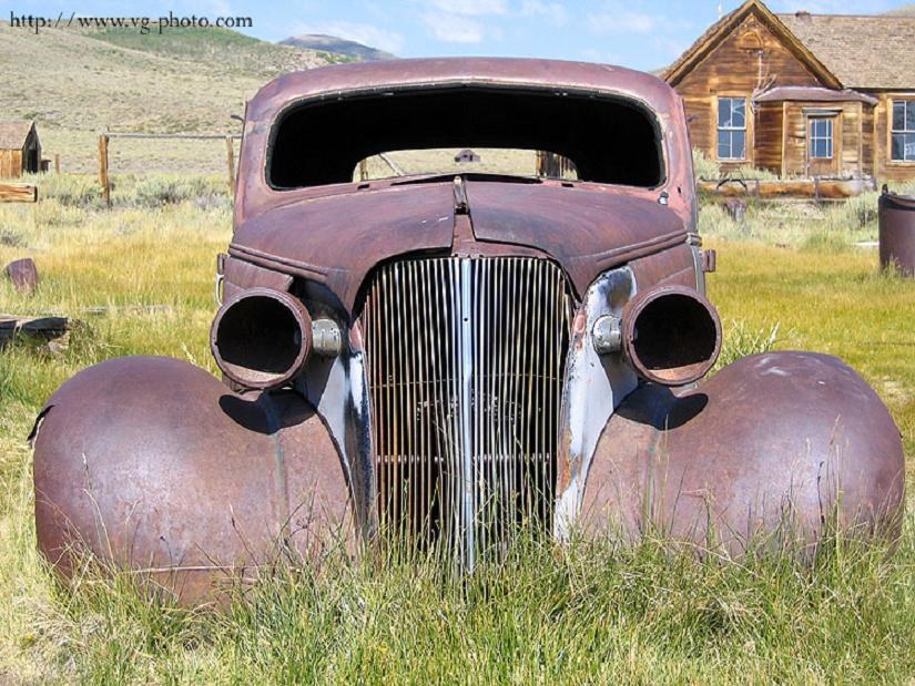 Rusty car in a field