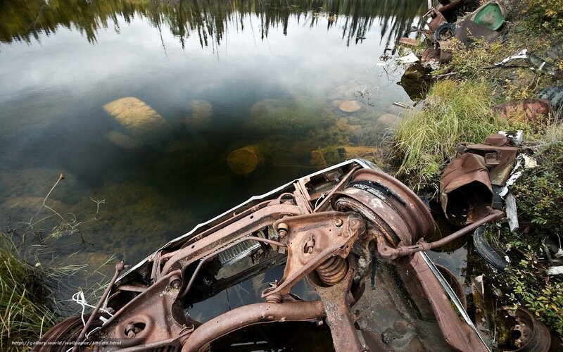 Rusty car in a lake