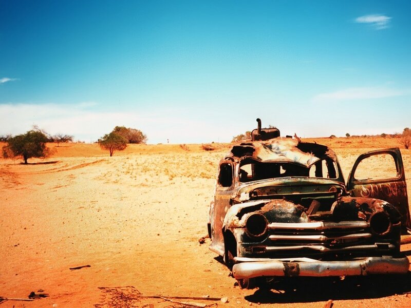 Rusty car in desert