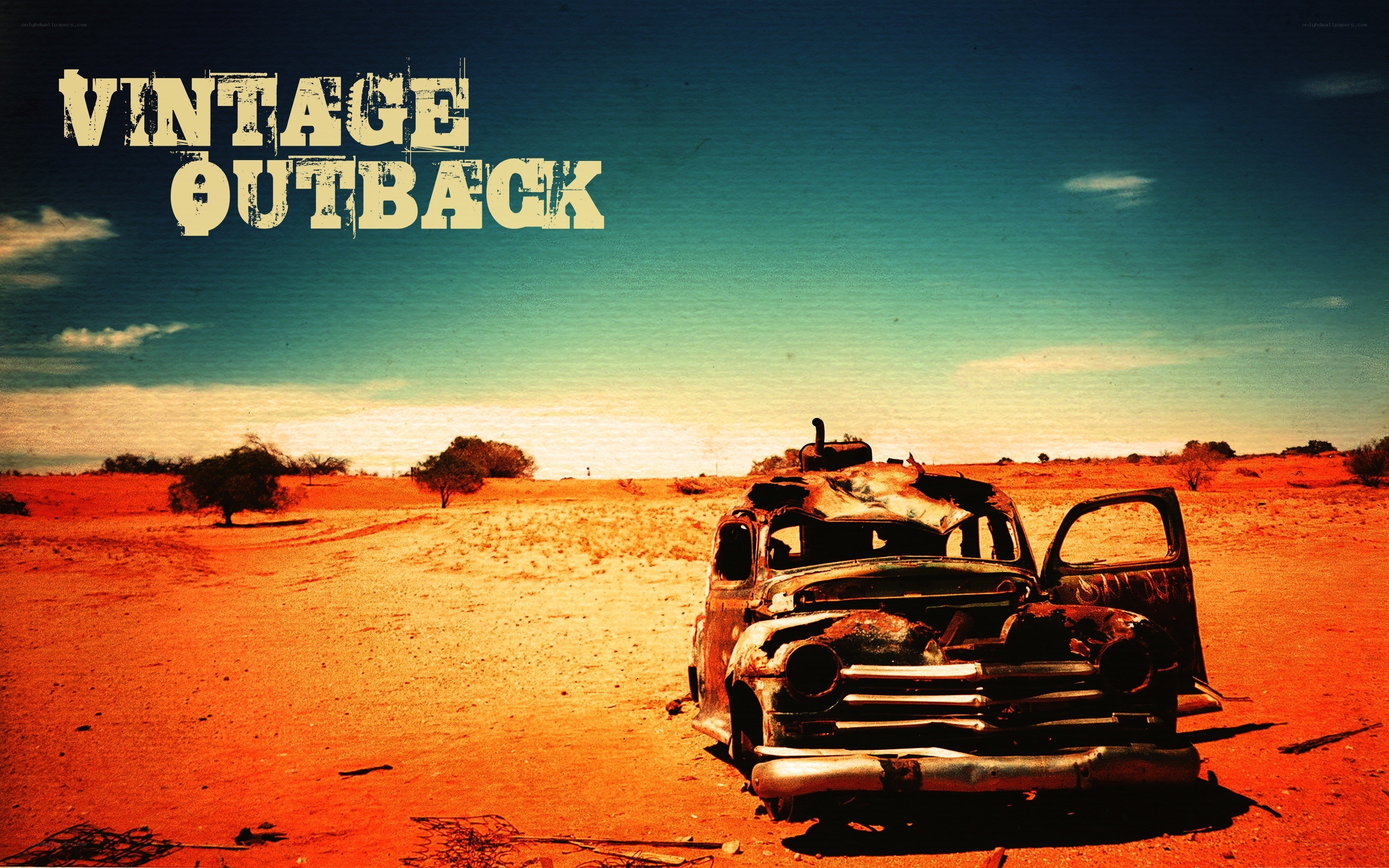 Rusty car in desert landscape