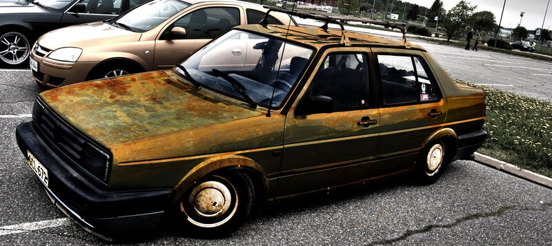 Rusty car in parking lot