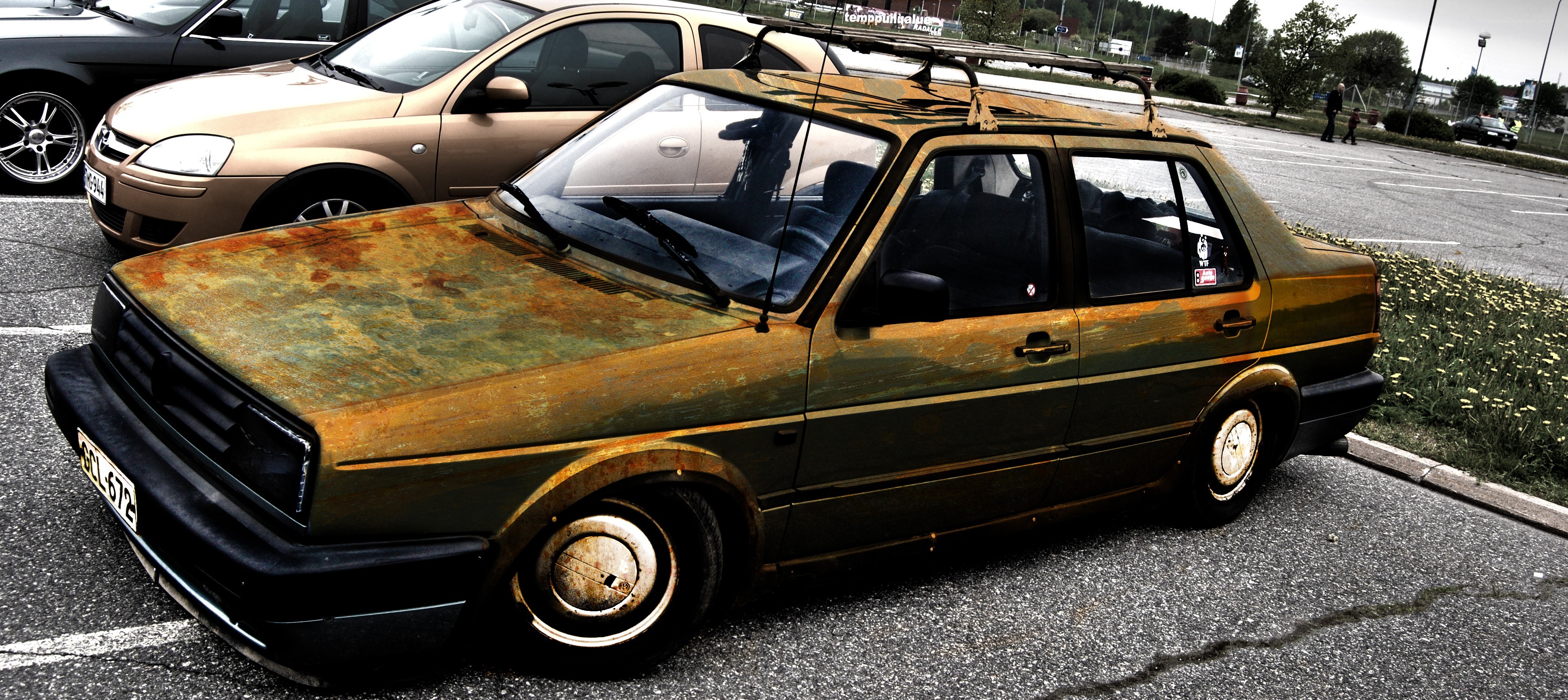 Rusty car in parking lot