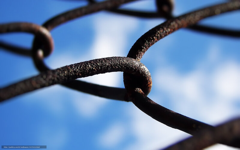 Rusty chain against blue sky