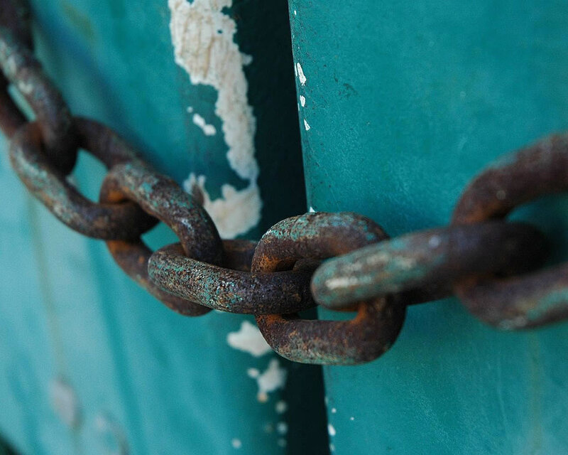 Rusty chain on a green door