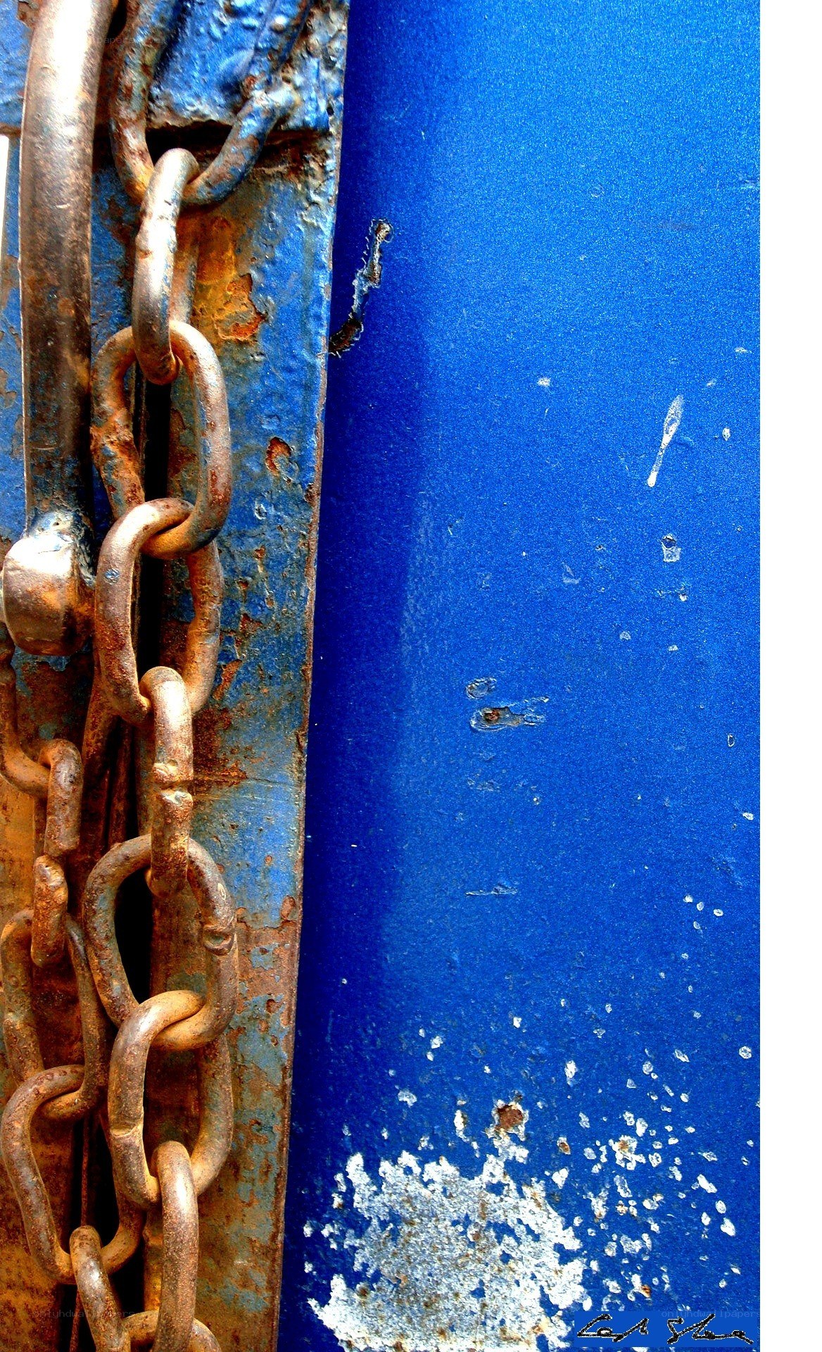 rusty chain on blue metal