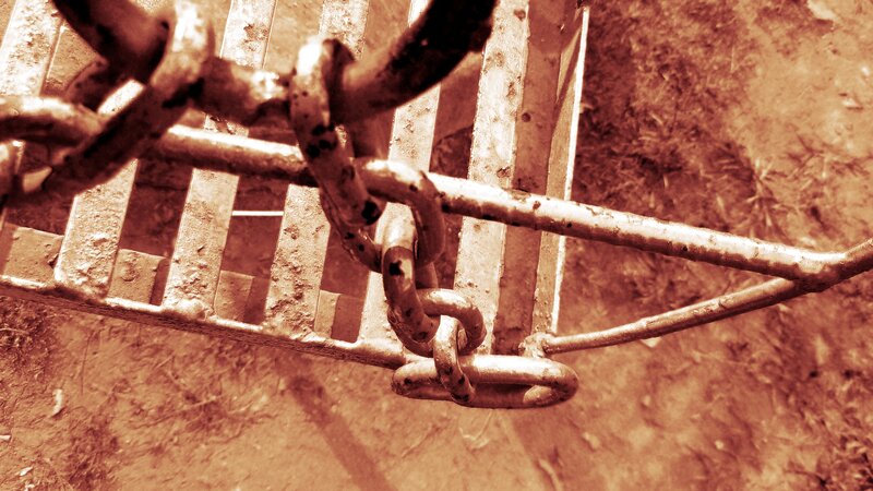 Rusty Chain on Metal Grate