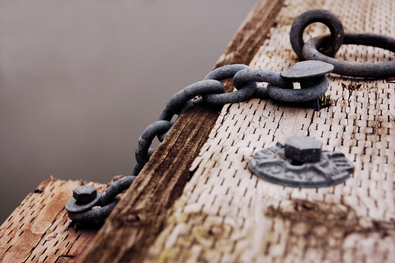 rusty chain on wooden dock