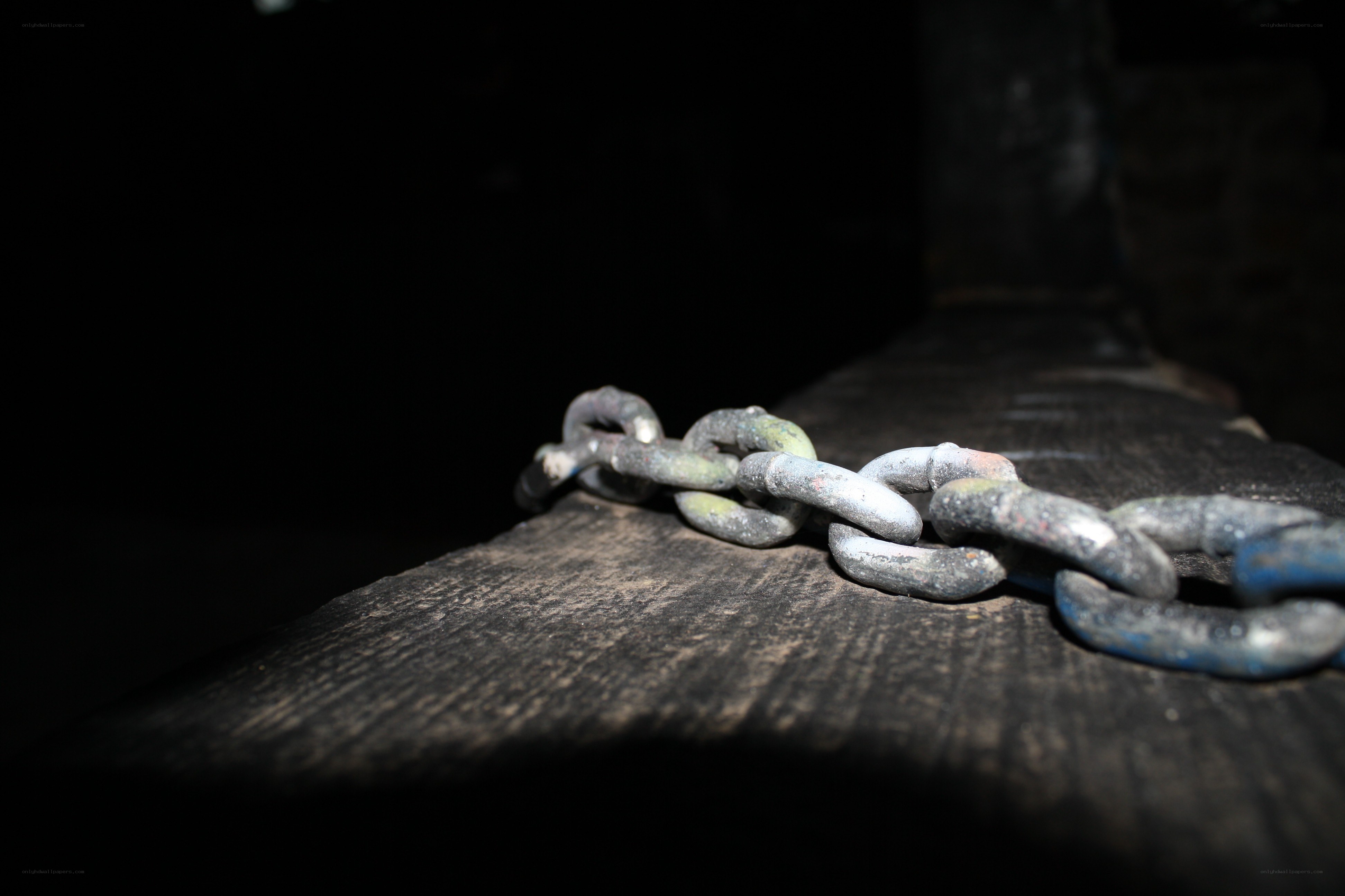 rusty chain on wooden surface