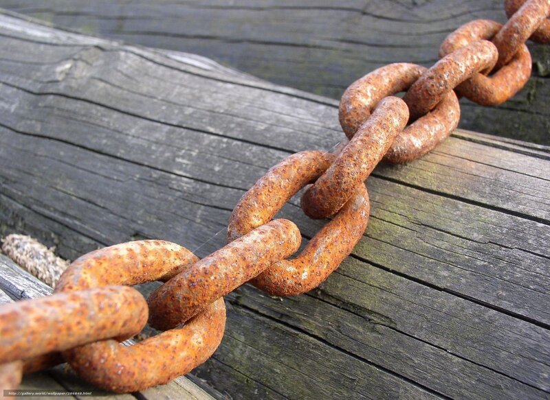 Rusty chain on wooden surface