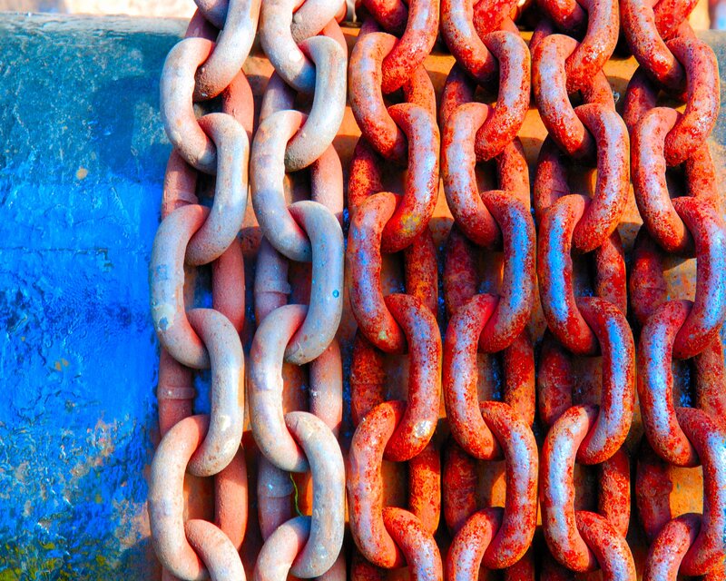 Rusty chains on blue surface