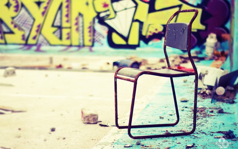 Rusty chair in graffiti alley