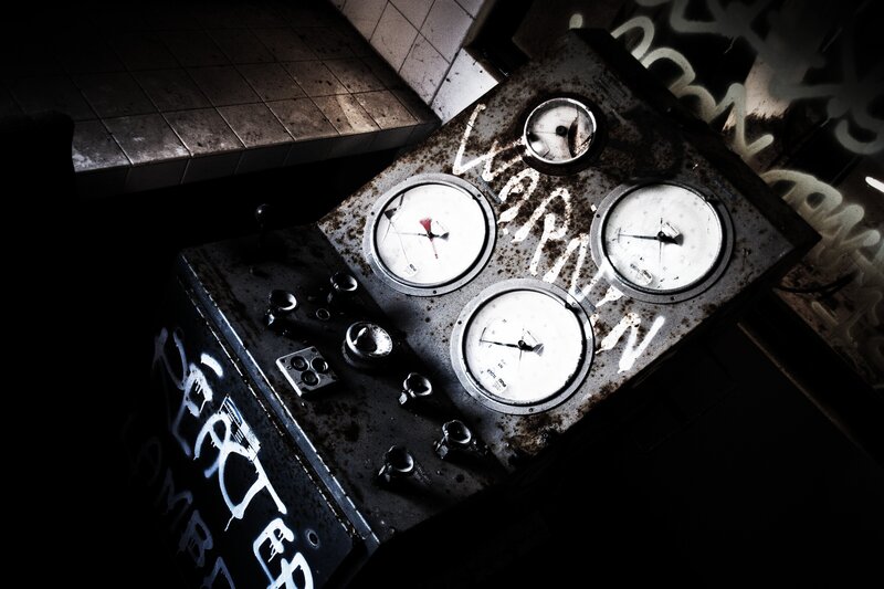 Rusty control panel with graffiti