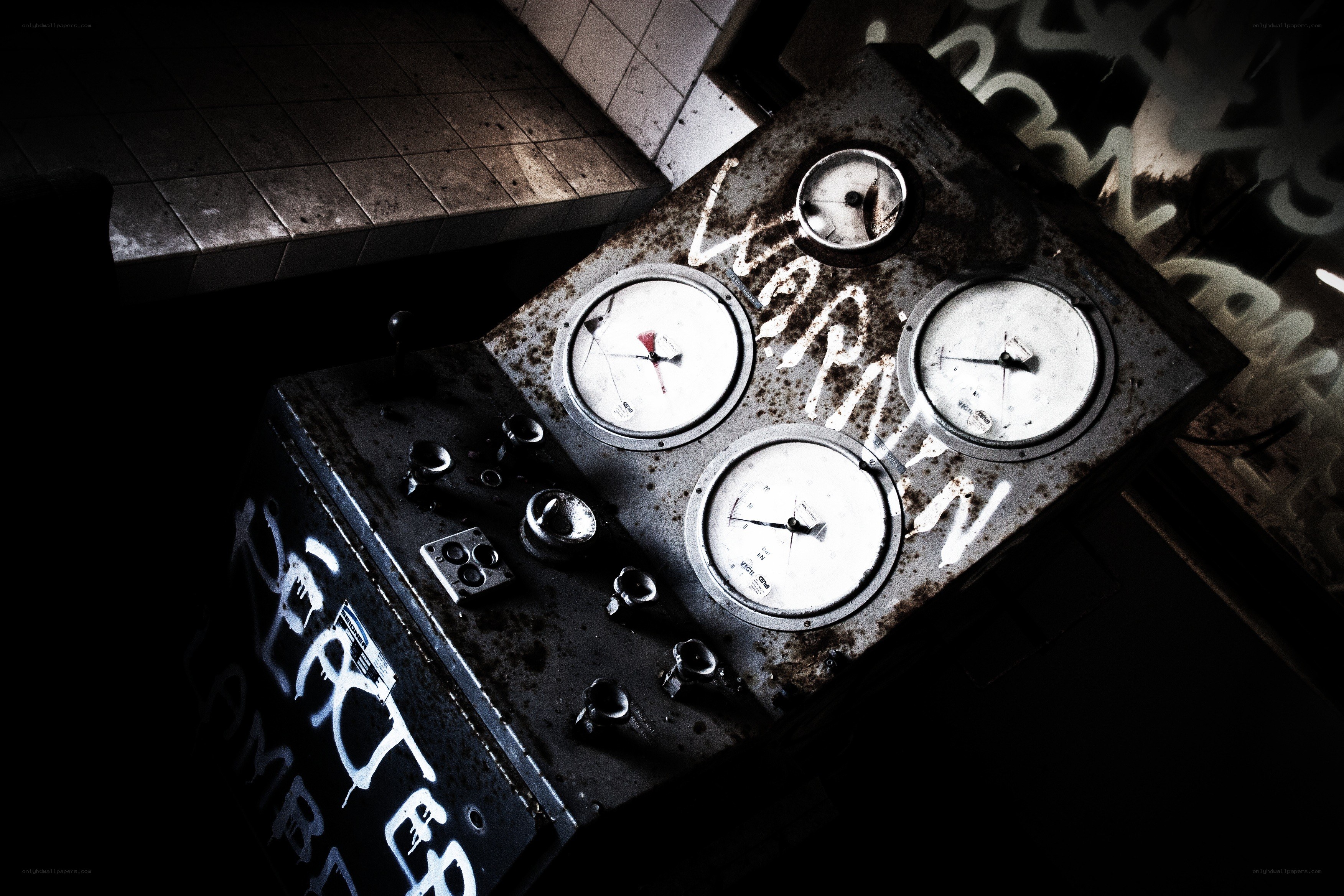 Rusty control panel with graffiti