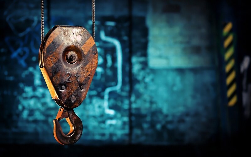 Rusty crane hook in industrial setting