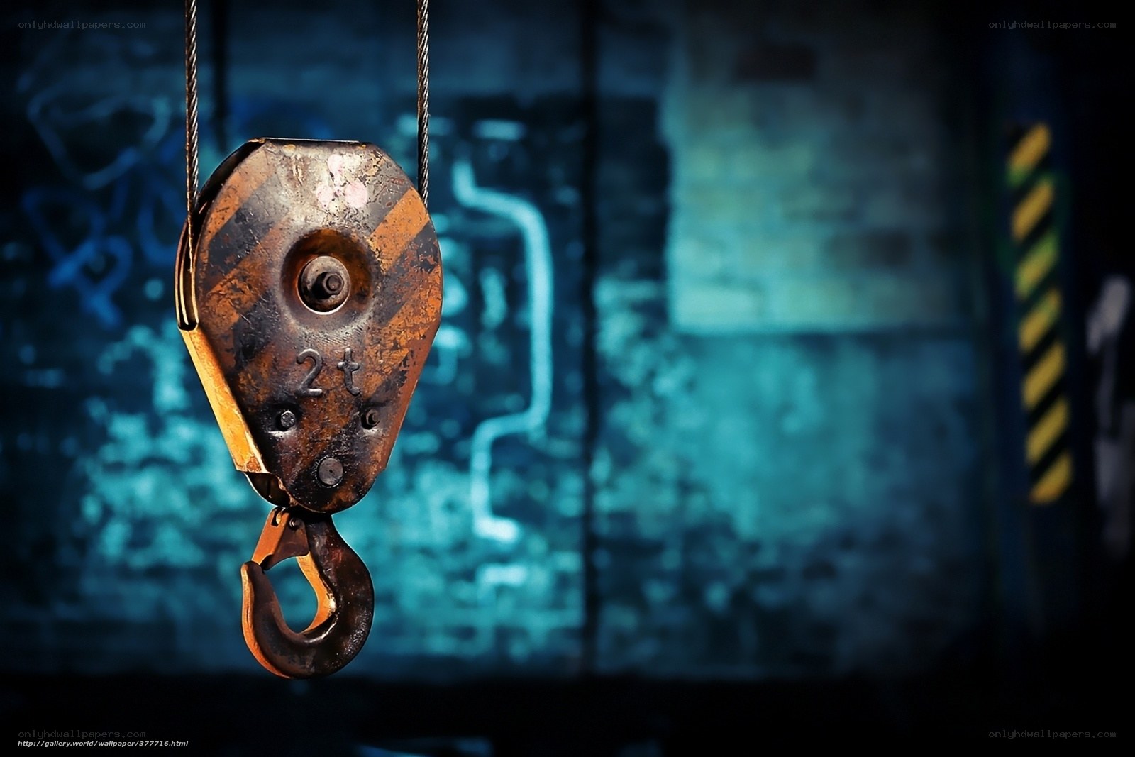 Rusty crane hook in industrial setting