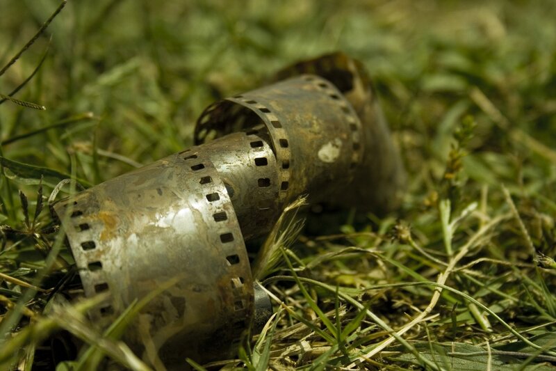 Rusty film reel in grass