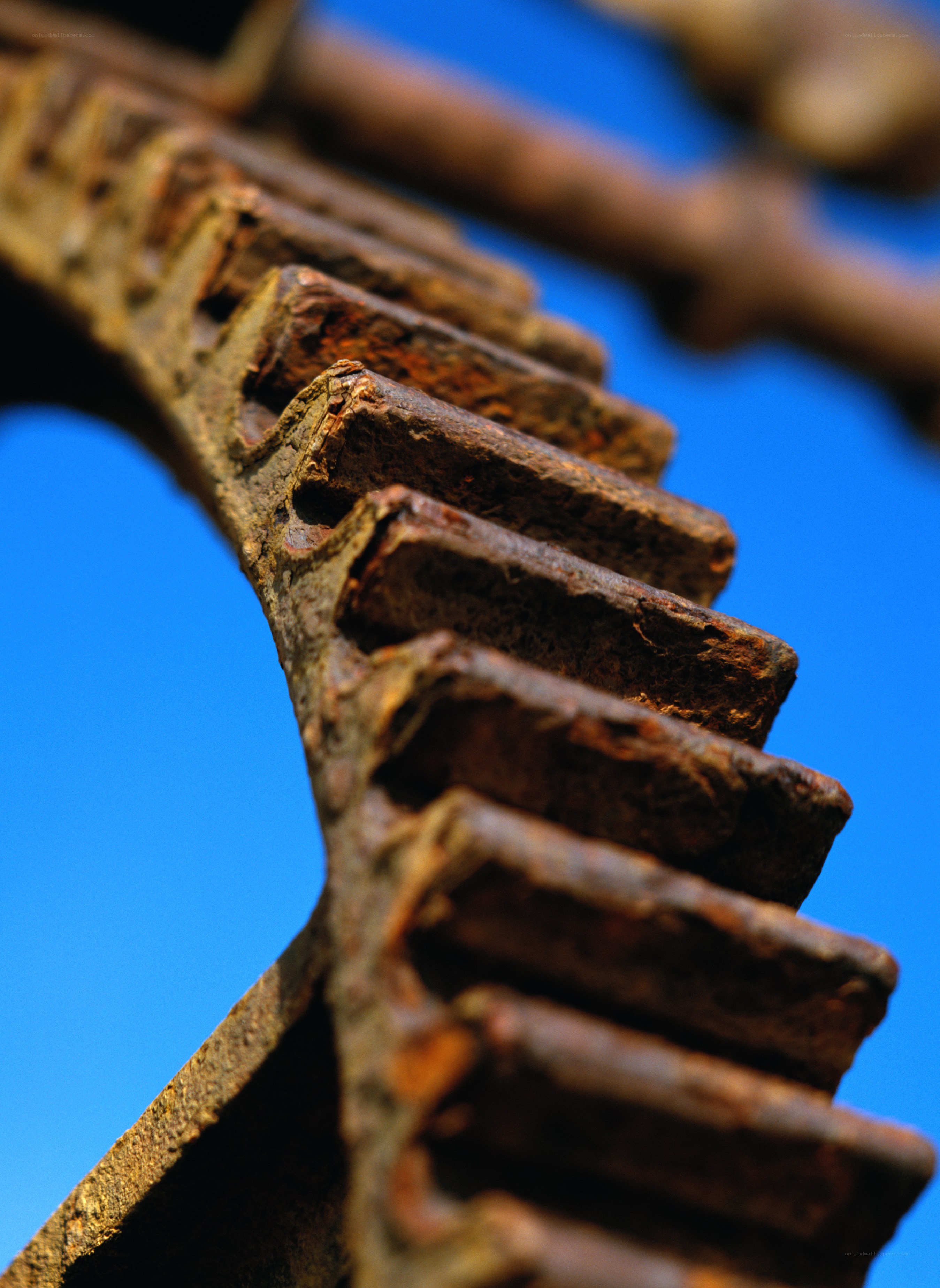 Rusty gear against blue sky