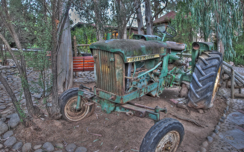 Rusty green tractor in garden