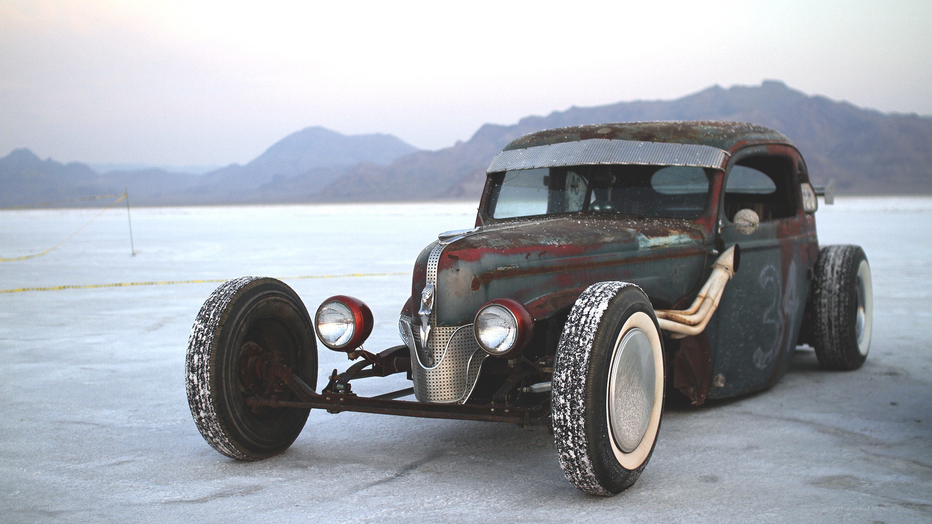 rusty hot rod on salt flat