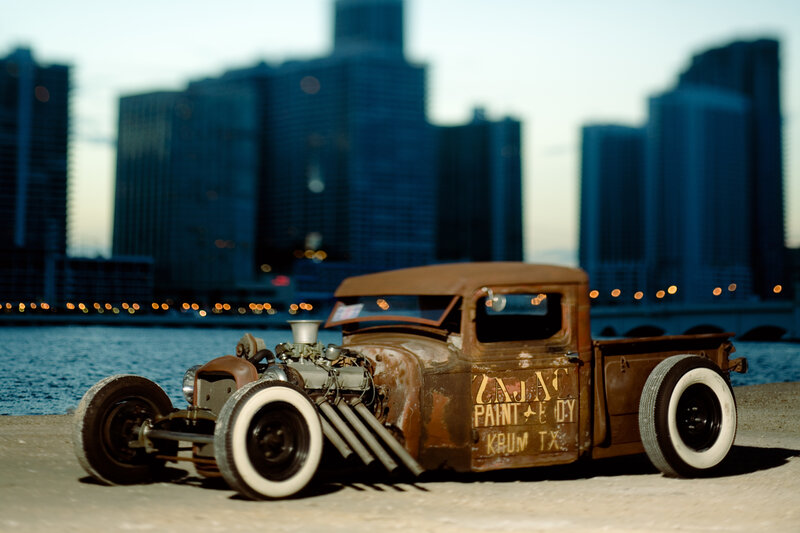 rusty hot rod truck by water