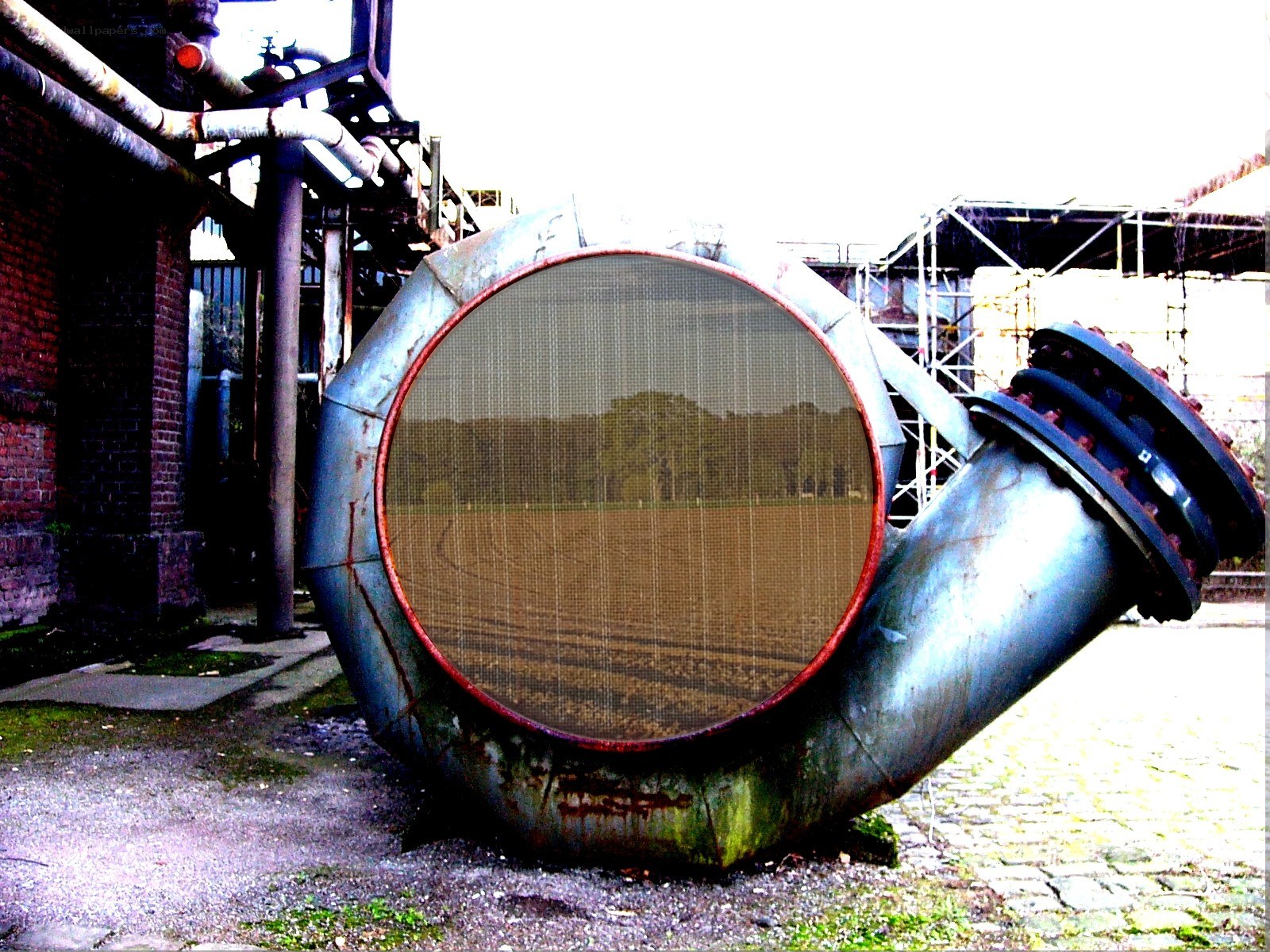 Rusty industrial pipe in a field