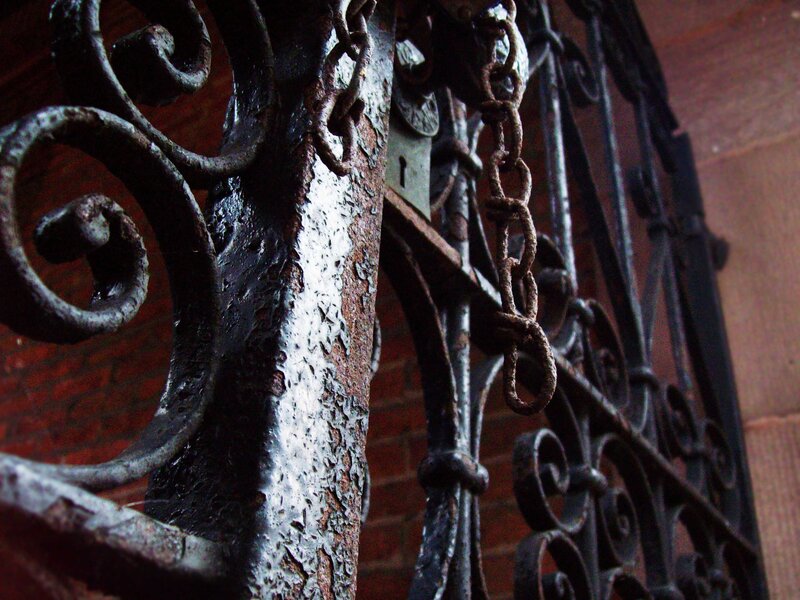 rusty iron gate with chain