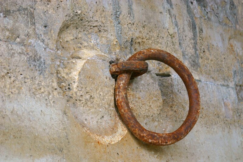 rusty iron ring in stone wall