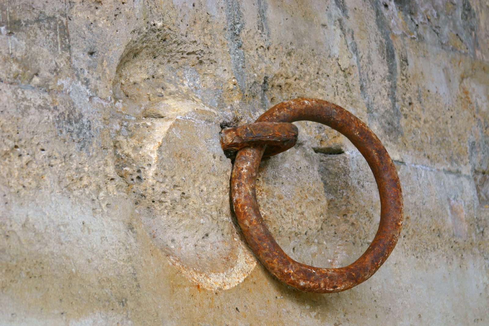 rusty iron ring in stone wall