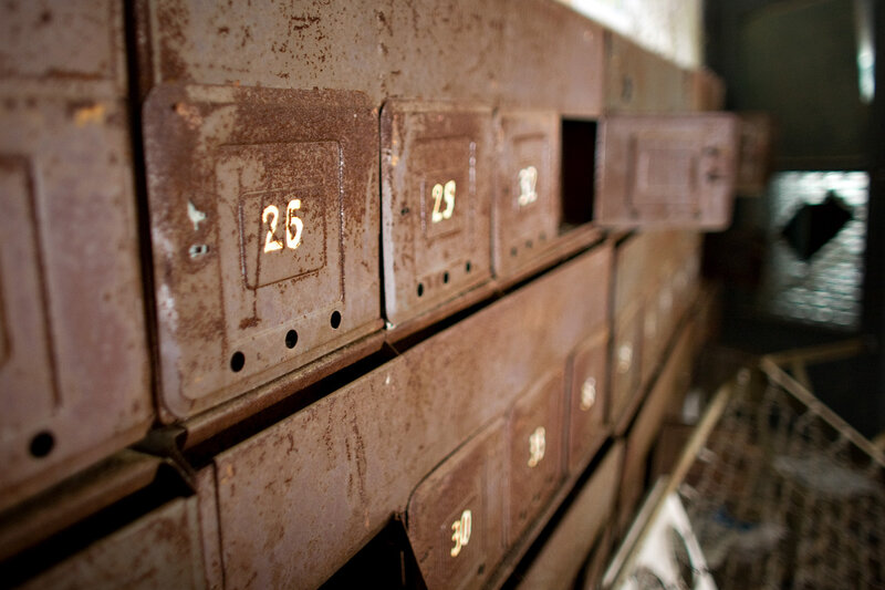 Rusty mailboxes in a dim room