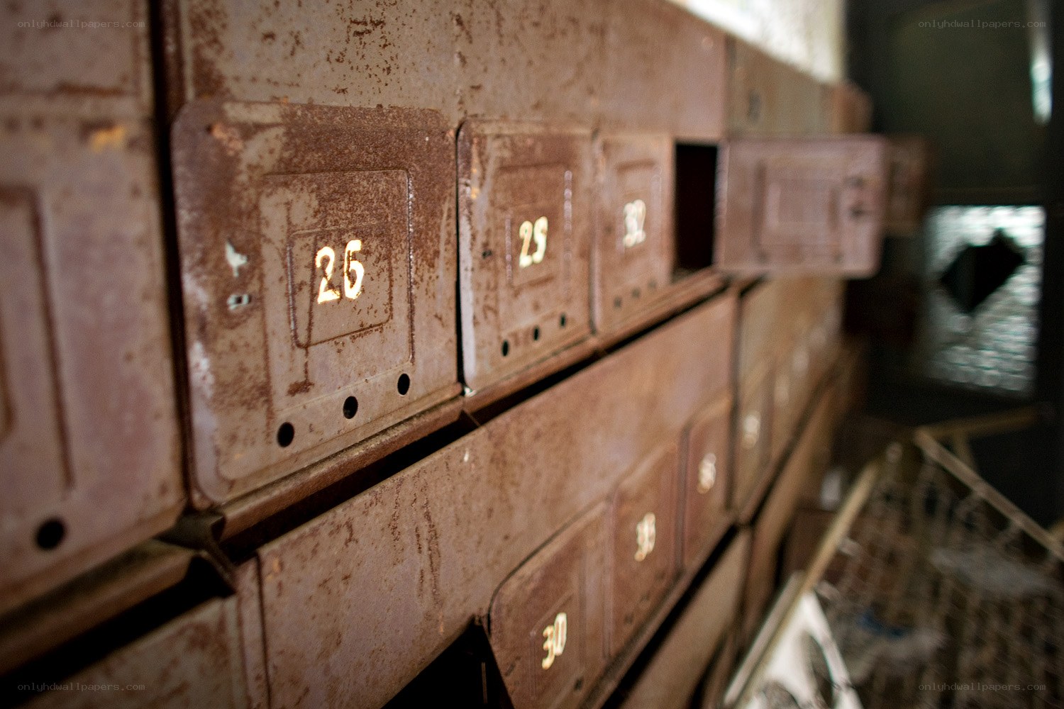Rusty mailboxes in a dim room