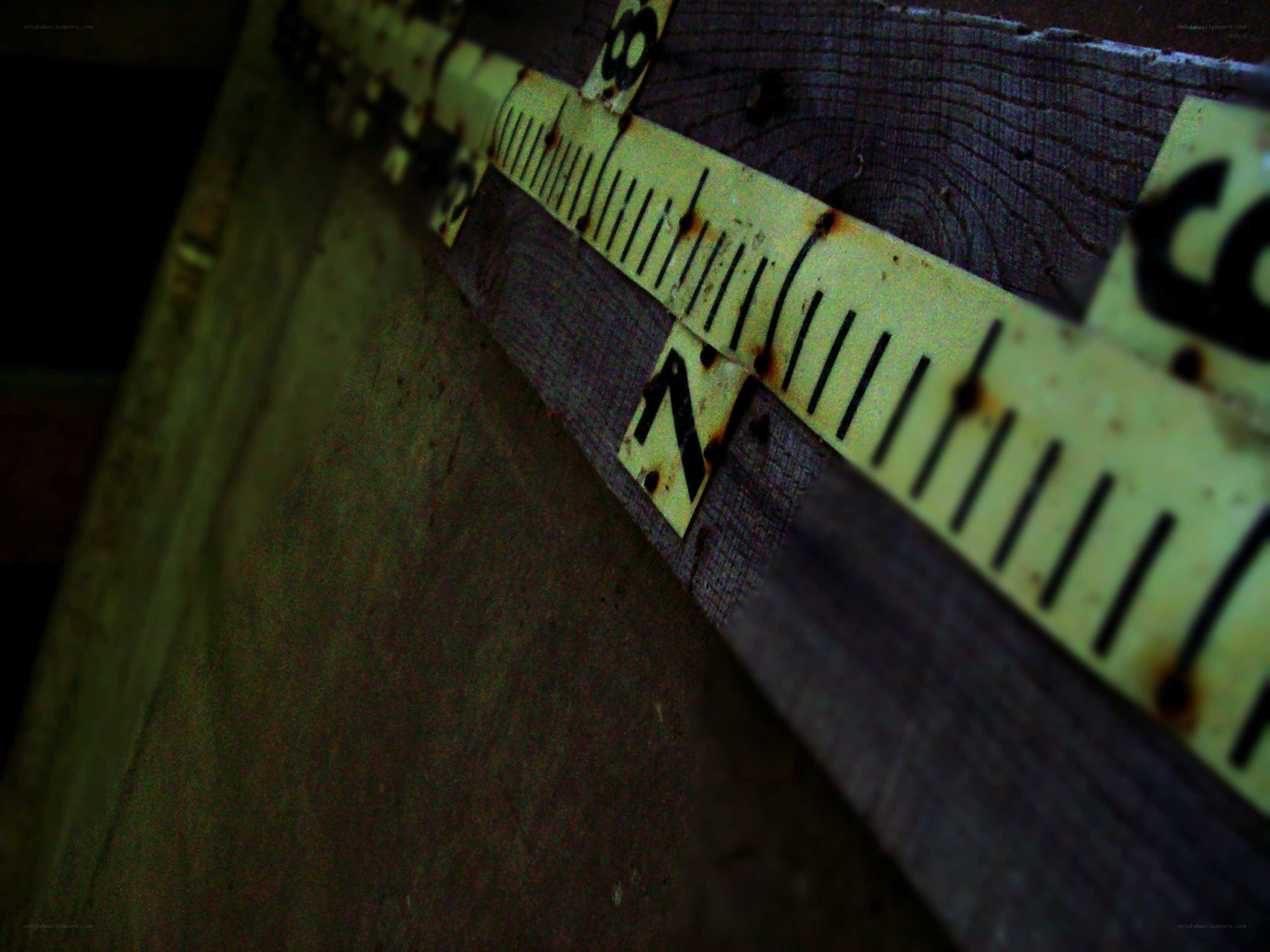 Rusty measuring tape on wood