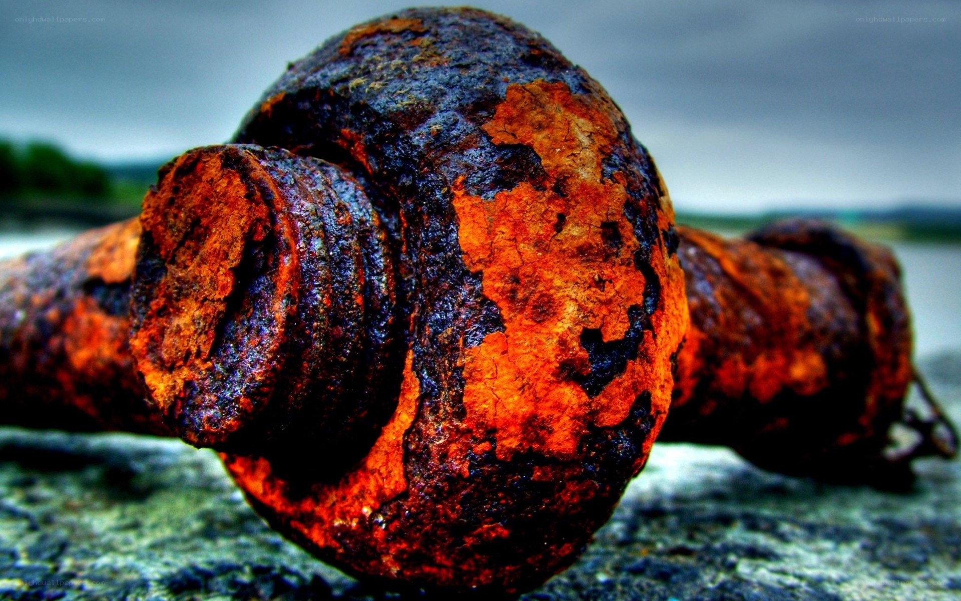 Rusty metal bolt on stone