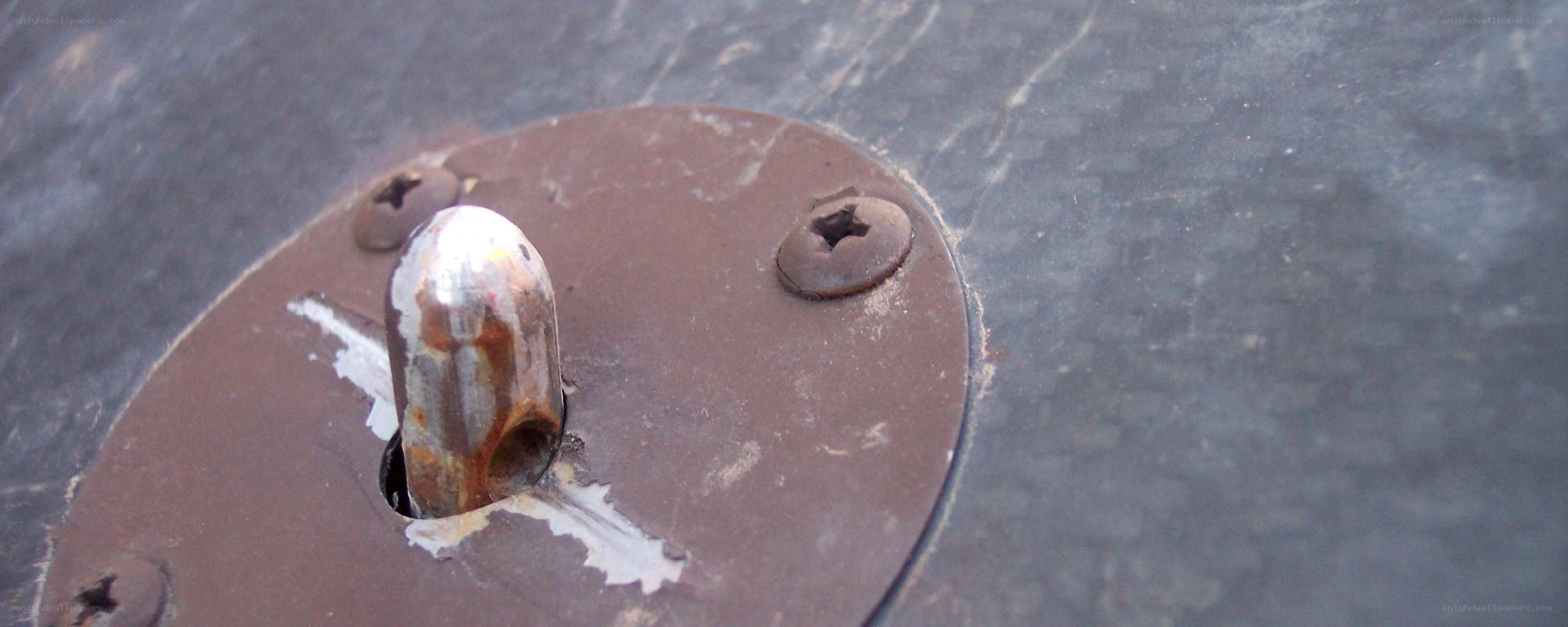 Rusty metal fixture on dark surface