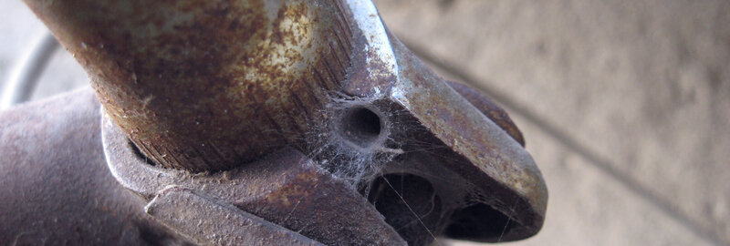 rusty metal with spider web