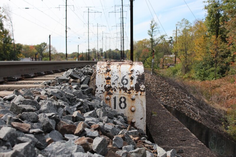 Rusty mile marker on train tracks