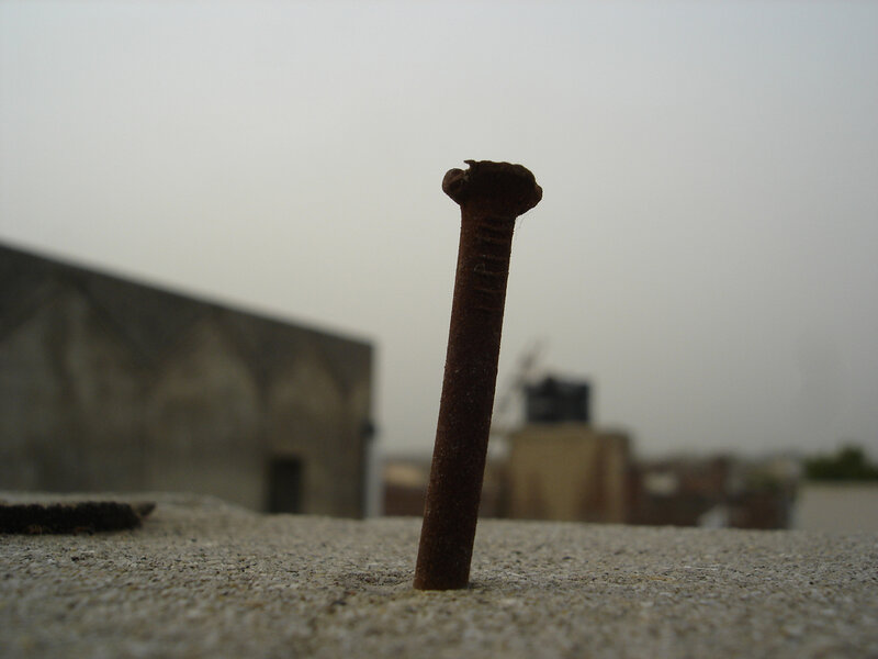 Rusty nail in concrete