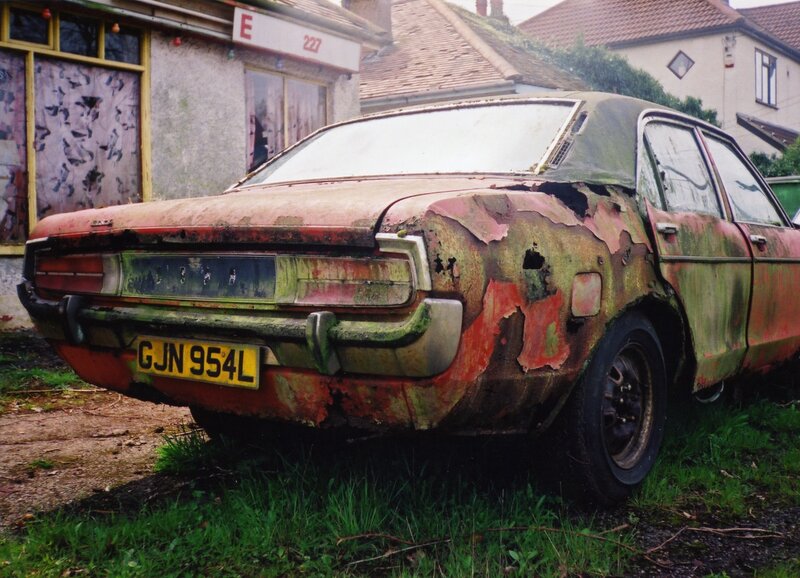 Rusty old car in a yard
