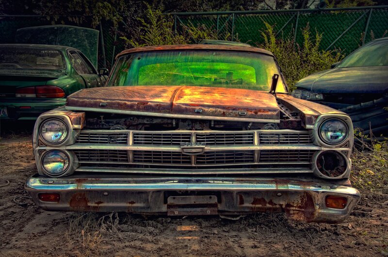 Rusty old car in junkyard