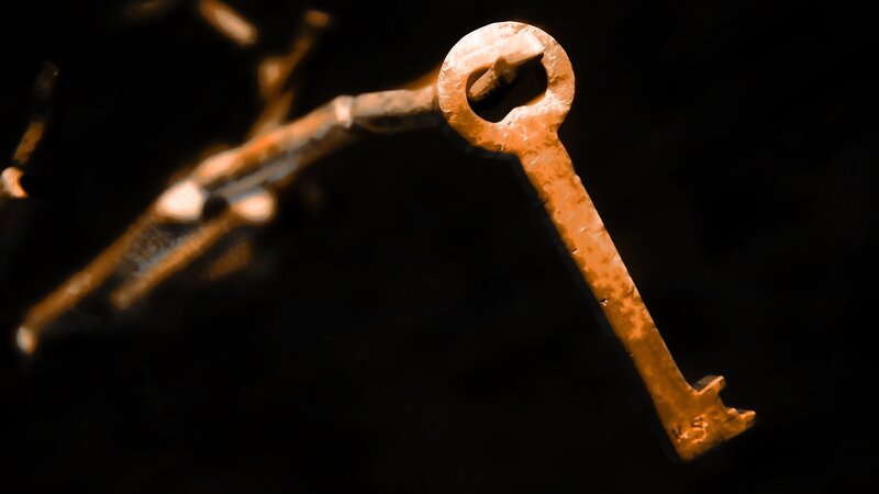 rusty old key on dark background