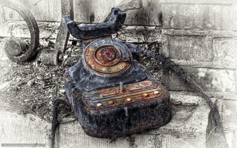 Rusty old telephone on concrete