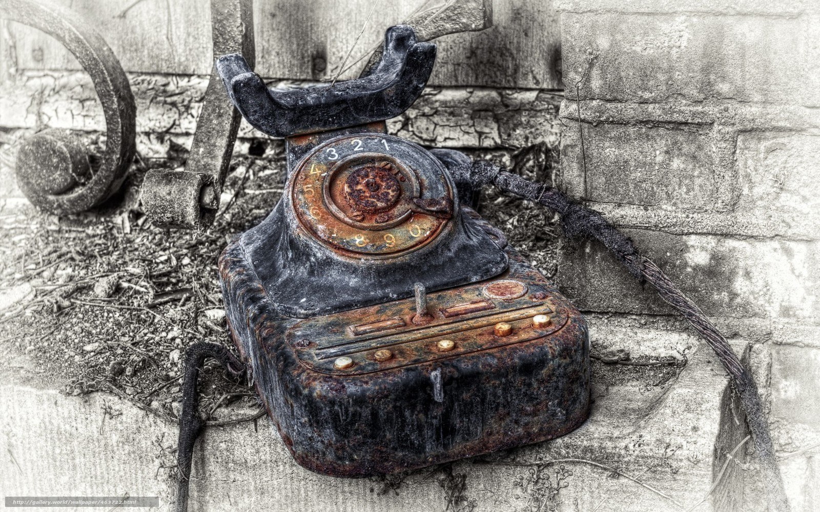 Rusty old telephone on concrete