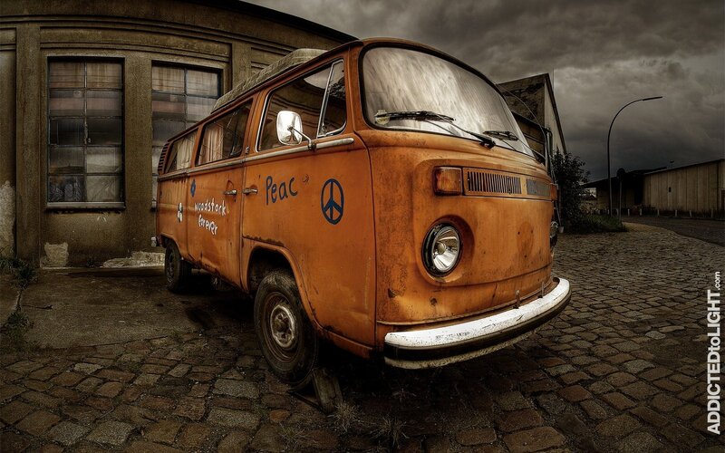 Rusty orange van on cobblestones