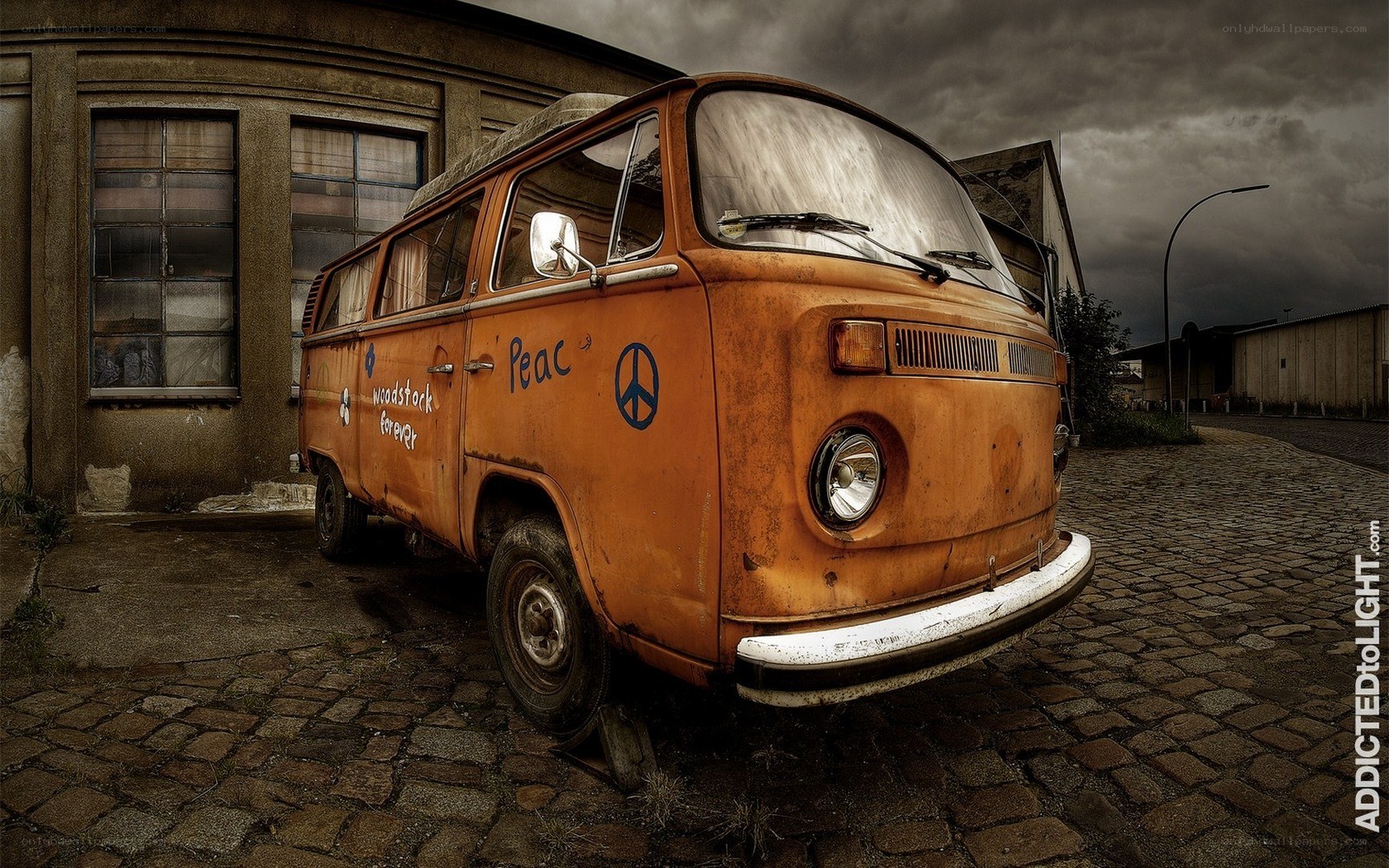 Rusty orange van on cobblestones