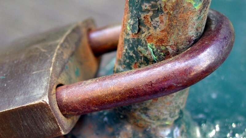 Rusty Padlock on Pole — Brown