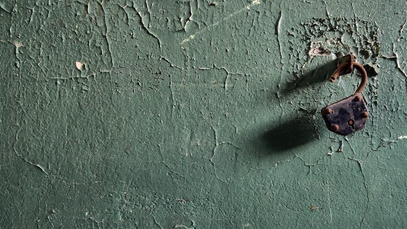 Rusty Padlock on Wall