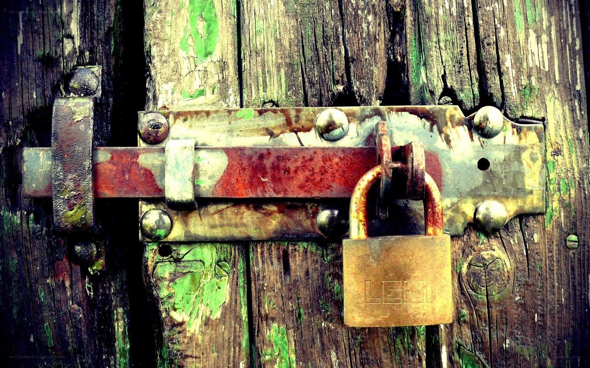 rusty padlock on wooden door