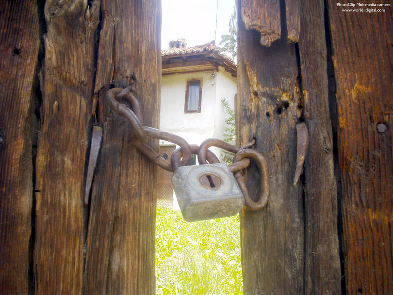 Rusty Padlock on Wooden Gate